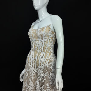 Close-up of the Marble Lace bridal gown, highlighting the intricate lacework, delicate beading, and V-neckline.