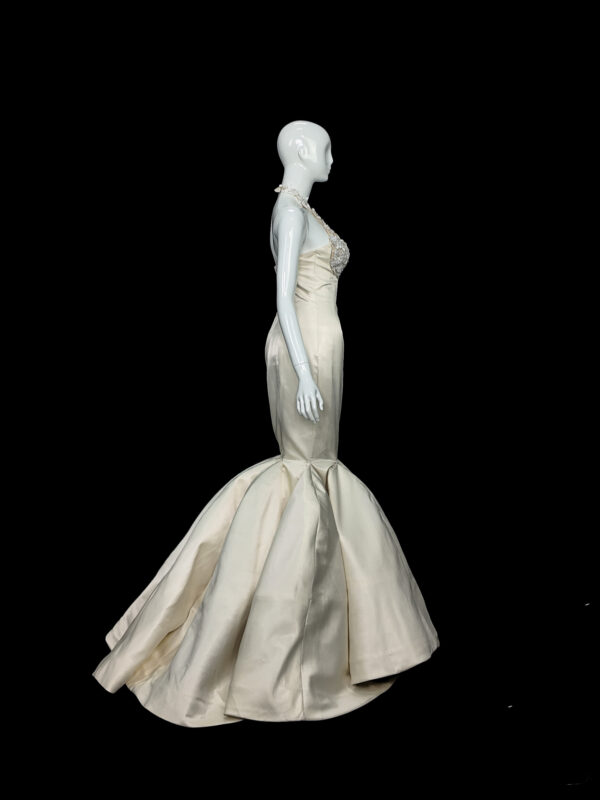 Close-up of The Bellflower wedding gown, highlighting the delicate lilac tulle layers and hand-placed floral appliqués on the bodice.